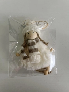 Detail of white and brown striped knit Christmas angel ornament with plush fur in packaging