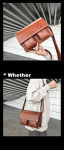 Detail of brown messenger bag showing dual front pockets and adjustable shoulder strap