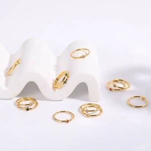 Detailed close-up of gold titanium steel rings with assorted colorful birthstones