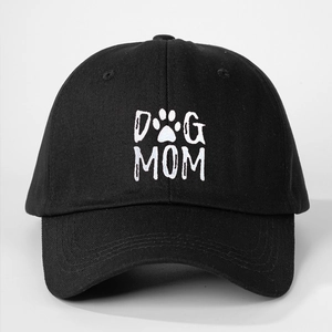 Close-up of the white Dog Mom text and paw print on the black cotton baseball cap