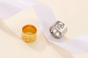Detailed view of gold and silver stainless steel rings with hollow tree of life pattern