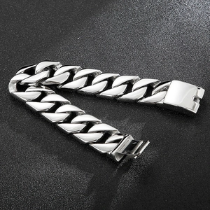 Detailed view of bold silver Cuban link chain bracelet with polished metallic finish