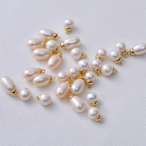 Detailed view of 6mm natural freshwater pearls with gold loops for DIY jewelry making