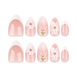Short almond press-on nails with 3D pink flowers, pearls, and gold star accents on nude base