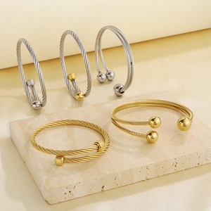 Detailed macro shot of hip-hop punk steel cable twisted bracelets in gold and silver finish
