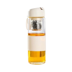 Glass tea separation cup with off-white leather sleeve and infuser on white background
