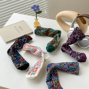 Detail of five pairs of vintage floral cotton socks with 3D embossed embroidery texture