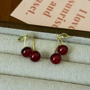 Elegant cherry drop earrings with red resin beads and green zircon leaf on gold hooks