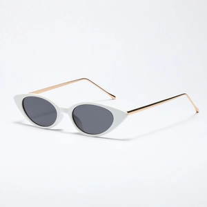 White cat-eye sunglasses with dark grey lenses and golden metal temples on white background