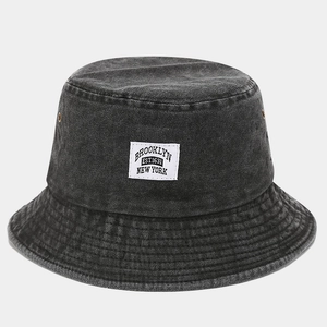 Detail view of washed cotton bucket hat showing fabric texture and Brooklyn cloth label