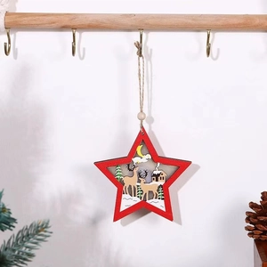 Detail of red wooden star ornament with carved deer scene and natural hemp rope