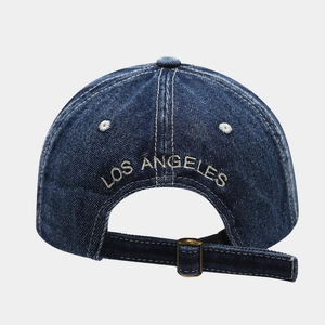 Close-up of adjustable metal buckle and Los Angeles embroidery on denim baseball cap