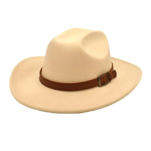 Detailed view of wide-brimmed felt hat with a brown leather band and rustic metal buckle