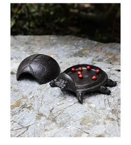 Detail of vintage cast iron ladybug key box showing the split lid and interior base