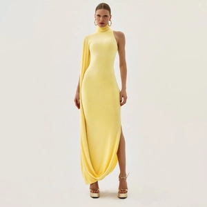 Detail of light yellow asymmetric dress with a high neck and elegant side slit