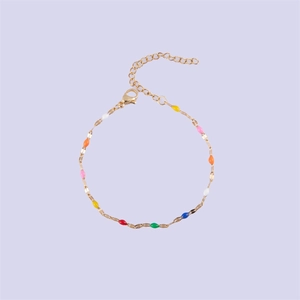 Golden stainless steel chain bracelet with seven multi-colored enamel oval beads and lobster clasp