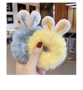 Detail of plush rabbit ear hair ties in bright yellow and grey-blue with soft texture