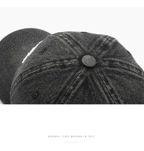 Detailed macro view of retro washed denim baseball cap crown with contrast stitching