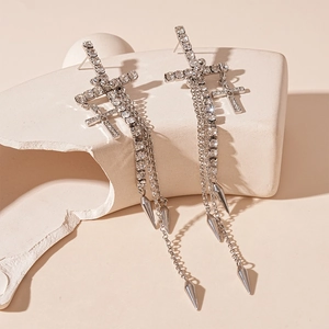 Detail of silver cross tassel earrings with rhinestones and punk style cone pendants