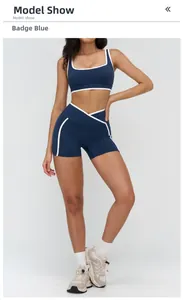 Close-up of badge blue yoga set with white contrast trim and crossover high waist design