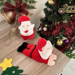 Festive Santa Claus plush toys on a wooden table with blurry Christmas tree background