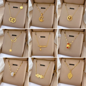Nine elegant gold titanium steel necklaces with geometric animal pendants in jewelry boxes