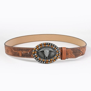 Close-up of Western belt featuring Longhorn Skull buckle and embossed floral leather