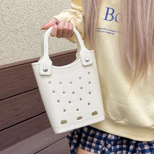 Close-up of a white waterproof EVA beach bag featuring a classic hollow hole design