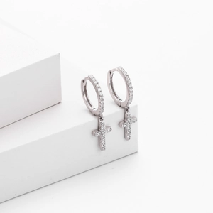 Detailed macro view of S925 sterling silver hallmark on cross hoop earrings with zircon
