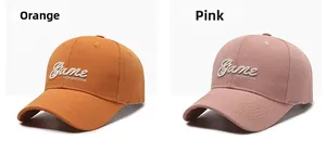 Close-up of 3D Game Competitive embroidery on orange and pink cotton baseball caps