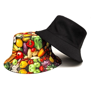 Reversible bucket hat with fruit vegetable print and solid black side for sun protection
