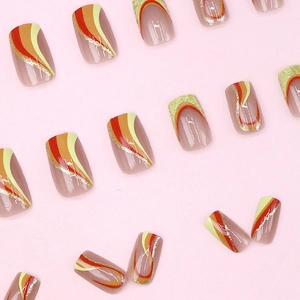 Press-on nails with retro wave patterns in red, orange, yellow and gold glitter