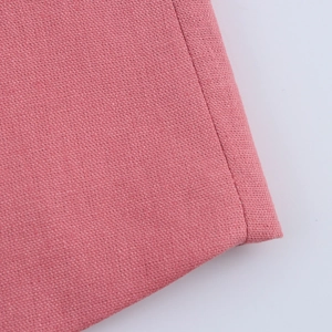 Close-up of pink linen-cotton fabric texture showing detailed woven pattern and material