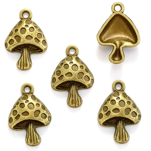 Five antique bronze mushroom charms for DIY jewelry making on a white background