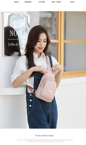 Close-up of pink monogram crossbody bag worn by a model in a casual outdoor setting