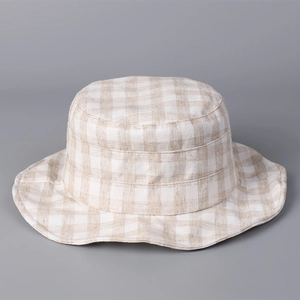 Detail view of the breathable linen texture and classic plaid pattern on the fisherman hat