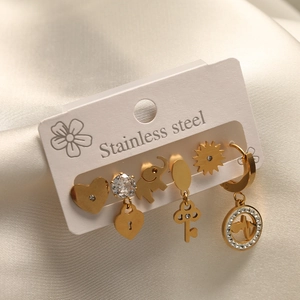 Detailed close-up of a 6-piece golden stainless steel earring set with zircon accents