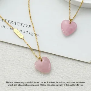 Natural rose quartz heart necklaces with gold lucky tag on a minimalist white backdrop