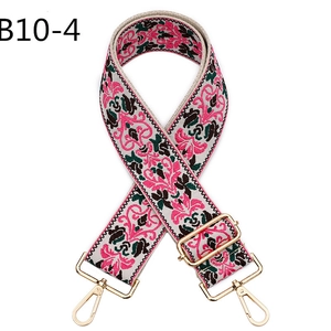 Close-up of bohemian embroidered wide shoulder strap with gold metal lobster clasps