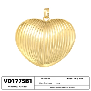 Detail of 18K gold plated brass heart pendant with vertical ribbed texture and 40x45mm size