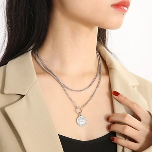 Silver double layer necklace with crown coin pendant and T-bar clasp on model