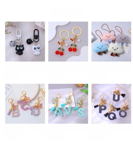 Detailed grid of cherry charms, plush clouds, and resin letter keychains with bell accents