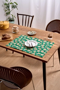 Close-up of festive Christmas cloth placemat with gingerbread man and snowflake patterns