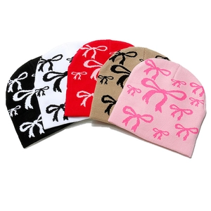 Winter knit beanies for women in five colors featuring all-over bow pattern jacquard