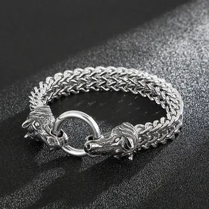 Detailed close-up of woven steel bracelet featuring dual horse heads and circular clasp