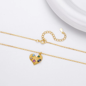 Close-up of S925 sterling silver heart necklace with colorful zircon on a white background