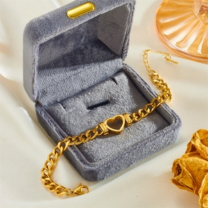 Gold stainless steel bracelet with hollow heart pendant in a velvet jewelry box