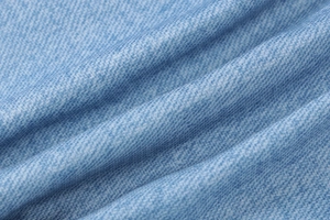 Close-up macro view of the premium blue denim fabric texture and diagonal twill pattern