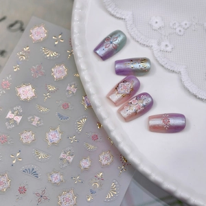 Golden mandala nail art stickers with celestial patterns shown on gradient false nails