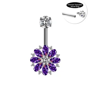 Macro detail of internally threaded navel ring with purple zircon flower charm